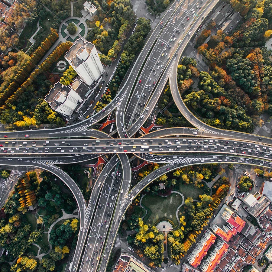 birdseye view of a freeway interchange during busy traffic hours